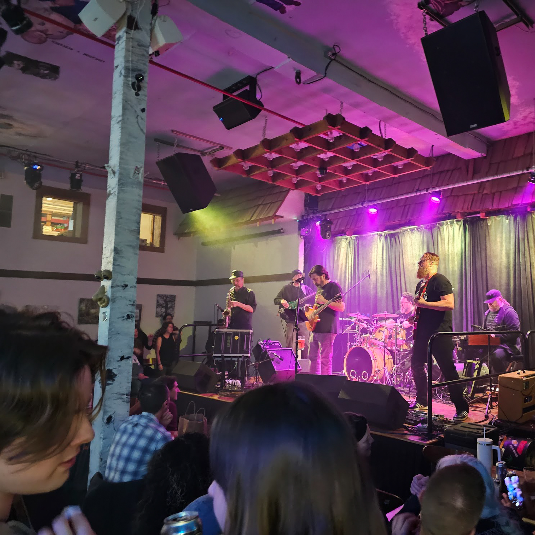 Wide shot of the band Stone Ape performing at Old World Center.